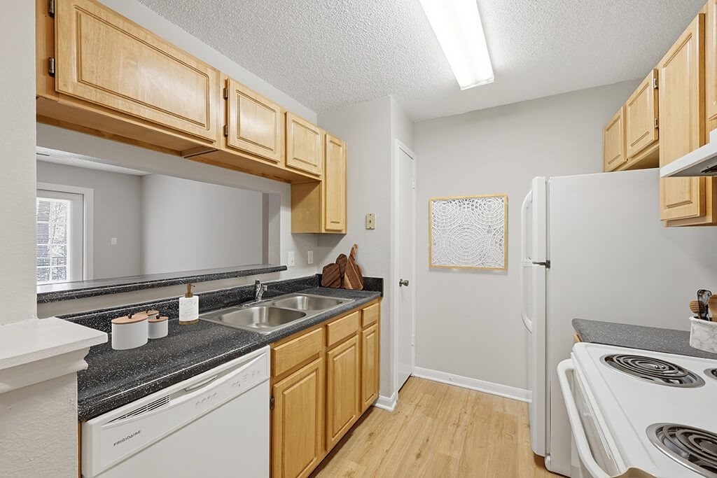 Kitchen with white appliances at Greens of Pine Glen in Durham NC